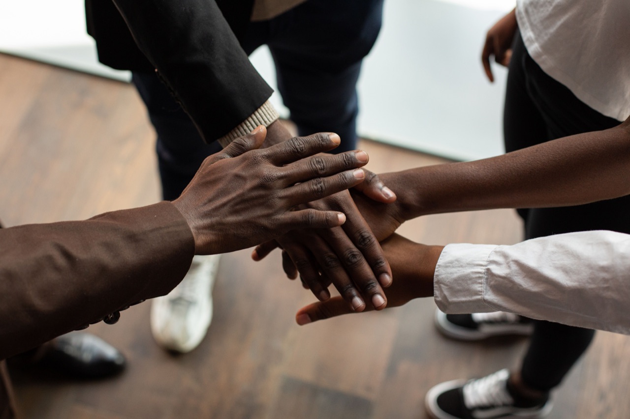 A group joining hands in partnership
